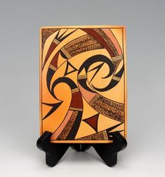 an orange and black box with designs on it