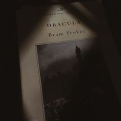 the book dracula by bram stoker is shown in front of a dark background