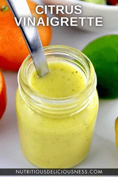 a glass jar filled with oranges next to some lemons and an orange peel