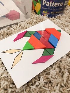 a piece of paper that is made to look like an origami bird on the floor