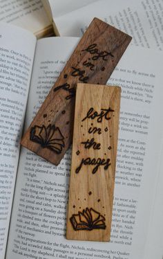 two wooden bookmarks with writing on them