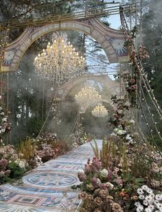 an elaborate garden with chandeliers and flowers