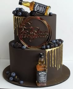 there is a chocolate cake with blueberries on it and a bottle of booze