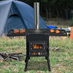 an outdoor stove with food cooking on it and a tent in the backgroud