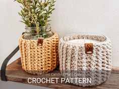 two crocheted baskets sitting on top of a wooden shelf next to each other