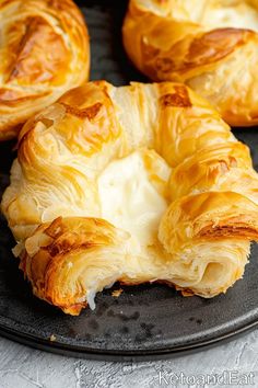 baked pastry items displayed on black plate on table