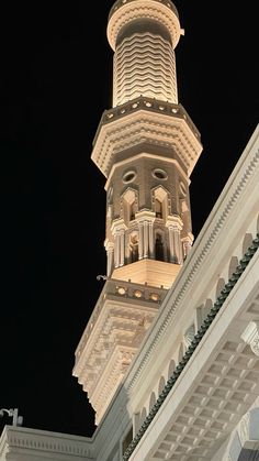 a tall white building with a clock on it's side and a skylight at the top