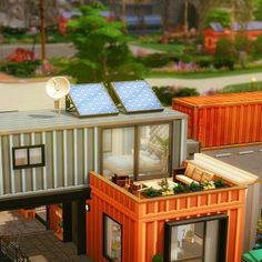 a tiny house made out of shipping containers with solar panels on the roof and windows