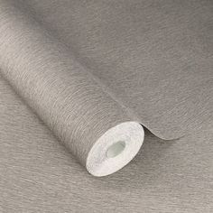 a roll of silver colored paper on top of a metal surface with a white background