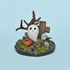 a figurine of two owls sitting on top of a rock