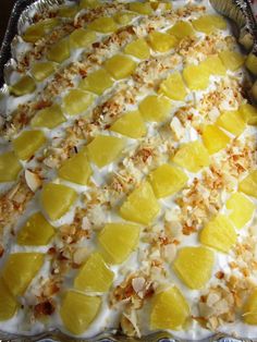 there is a cake that has been made with pineapples and coconut on top