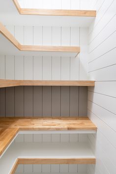 empty wooden shelves in a white painted room