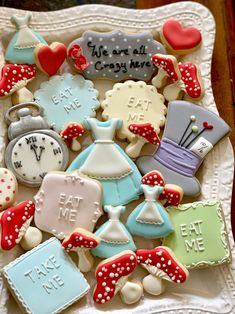 decorated cookies are arranged on a white plate