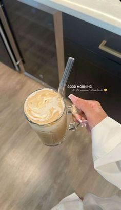 a woman holding a cup of coffee in her hand with the words good morning on it