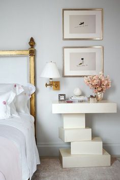 a bed room with a neatly made bed and pictures on the wall