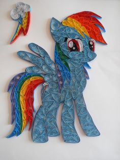 a paper mache of a rainbow pony with swirls on it's tail