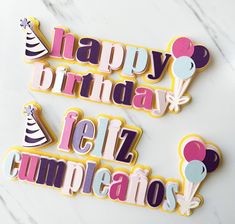 two decorated cookies with the words happy birthday and feliz cumplentos