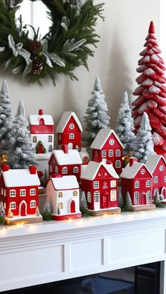 a christmas mantel with red houses and trees