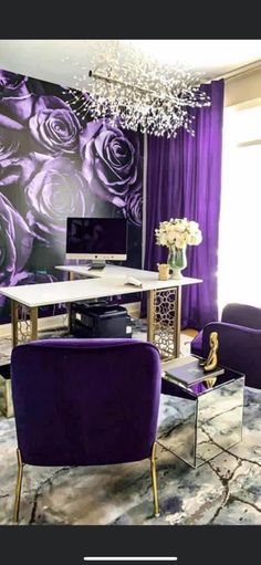 a living room with purple chairs and a white table in front of a floral wall mural