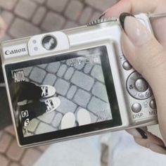 a person holding up a camera to take a picture