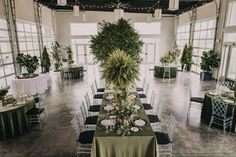 an indoor venue with tables, chairs and plants