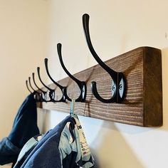 a coat rack with four coats hanging on it