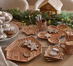 gingerbread cookies and pastries are arranged on the table for christmas dinner guests to enjoy