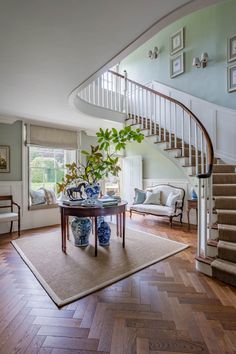 a living room filled with furniture and a spiral staircase