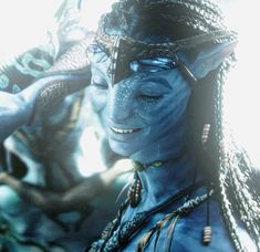 a woman with blue skin and braids on her head is looking into the distance