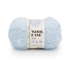 wool ease yarn in light blue with white lettering on the front and bottom, sitting on a