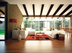 a living room filled with white furniture and wooden floors