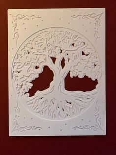 a white paper cutout with a tree on it