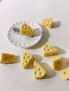 several pieces of cheese on a plate with a knife