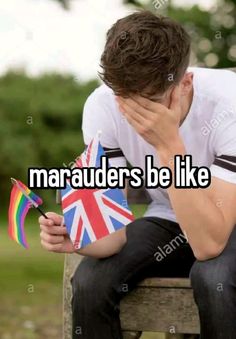 a man sitting on top of a wooden bench next to a rainbow flag and the words maraaders be like