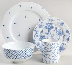 a blue and white dinnerware set on a table