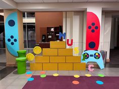 an indoor play area for children with colorful walls and floor tiles on the ground,