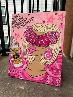 a painting on the ground with pink and black paint, featuring a woman's face