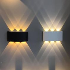 two lights are on the wall next to each other