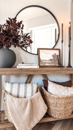 a wooden table topped with baskets filled with pillows