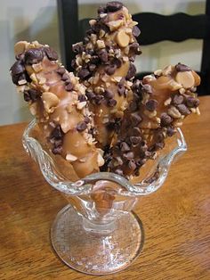 a glass vase filled with chocolate covered donuts