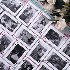 several playing cards with pictures of people and dogs on them, surrounded by flowers in black and white