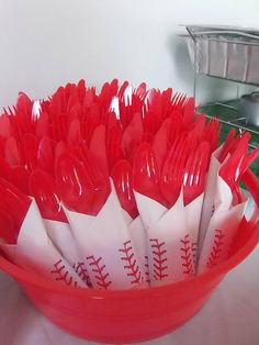 red plastic utensils in a baseball themed bowl