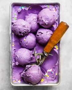 purple ice cream with sprinkles and a corkscrew in a metal container