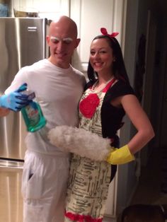 a man and woman in costumes standing next to each other with cleaning supplies on their hands