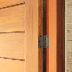 a close up of a door handle on a wooden door