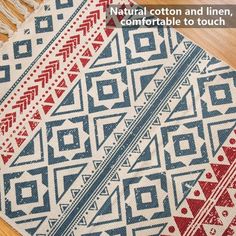 a red, white and blue rug sitting on top of a wooden floor