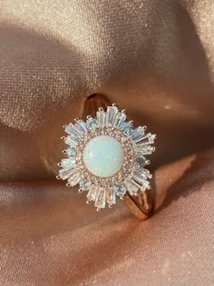 We couldn't find a showstopping opal statement ring for a reasonable price, so we decided to make our own and we absolutely did not hold back! 🤩 Our Supernova Ring is the opal ring of our dreams, bursting with a bright halo of explosive cubic zirconia baguettes around a mesmerizing, multidimensional simulated opal. The dazzling shine of our Supernova Ring is matched only by the astronomical burst of an exploding star. 🌟 * * * Don't know your ring size? View our Ring Size Guide * * * ………………………… Opal Statement Ring, Cute Engagement Rings, Opal Wedding, Future Engagement Rings, Dream Engagement Rings, Fantasy Jewelry, Opal Ring, Dream Jewelry