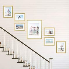 a staircase with pictures on the wall next to it