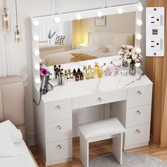 a white vanity with lights on it in a bedroom