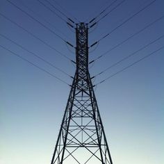 an electric tower with power lines above it